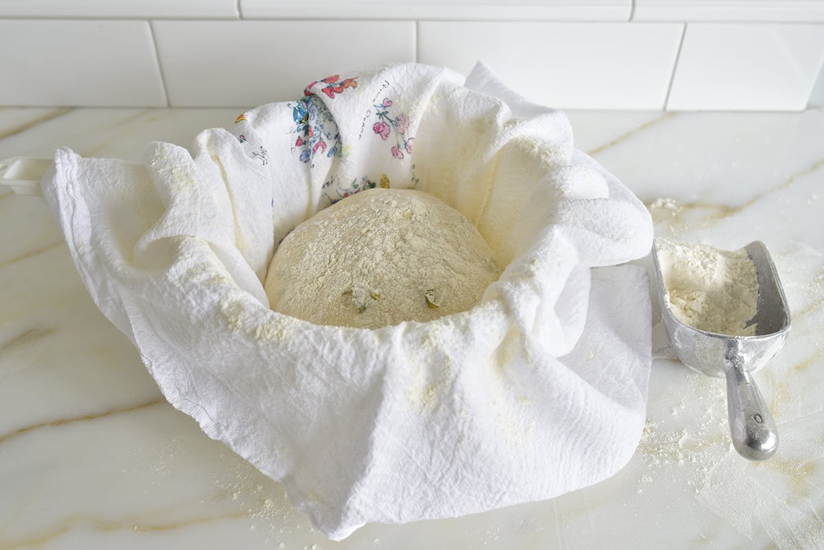 Dough ball in a towel set in a colander