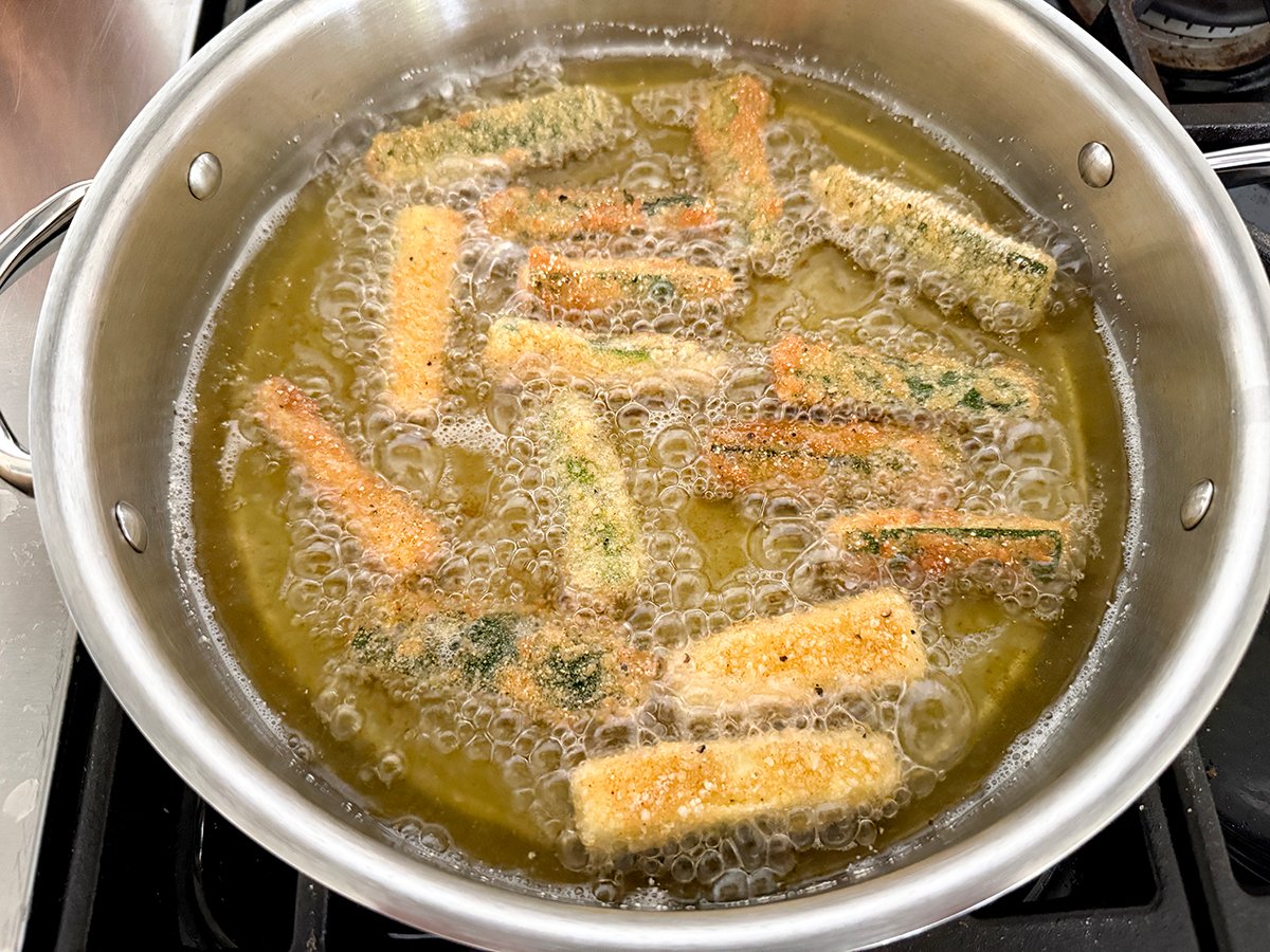zucchini in hot frying oil