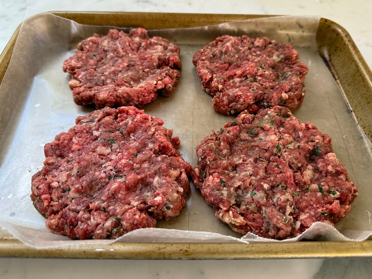 meat patties on a sheet pan