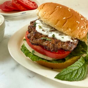 Lamb burger with white sauce on top