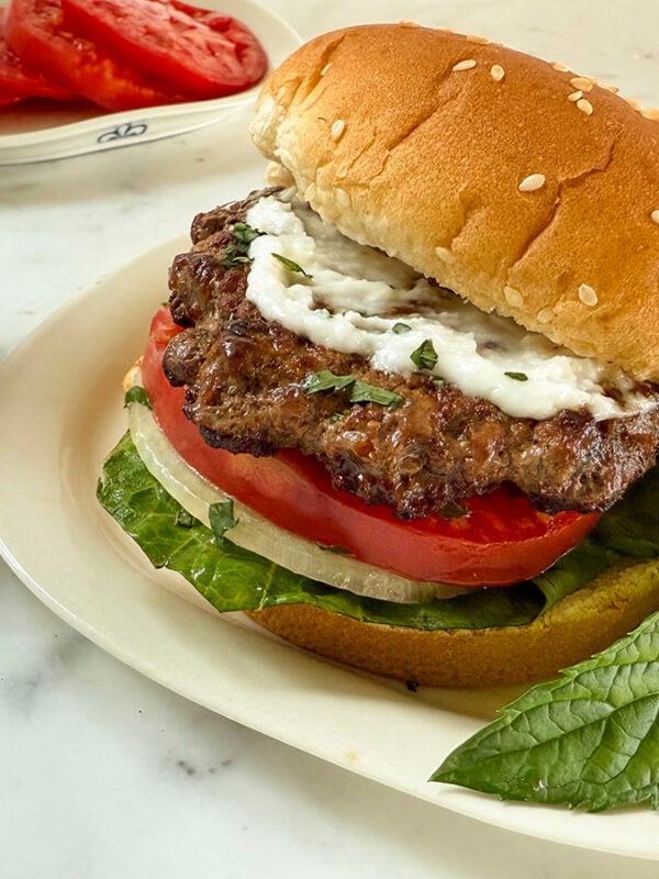 Lamb burger with white sauce on top
