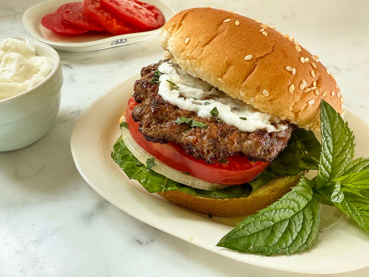 Lamb burger with white sauce on top