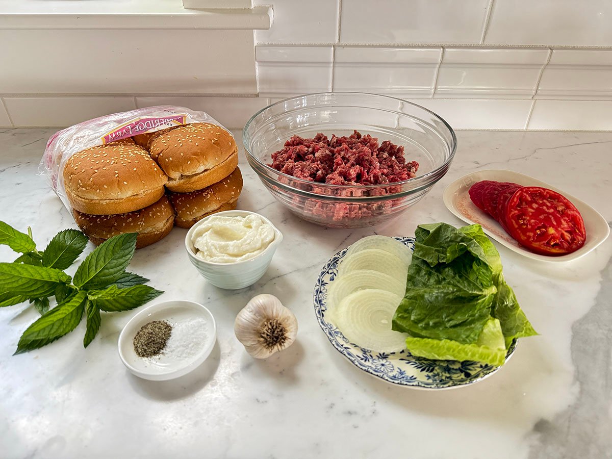 Ingredients for burgers on a marble countertop