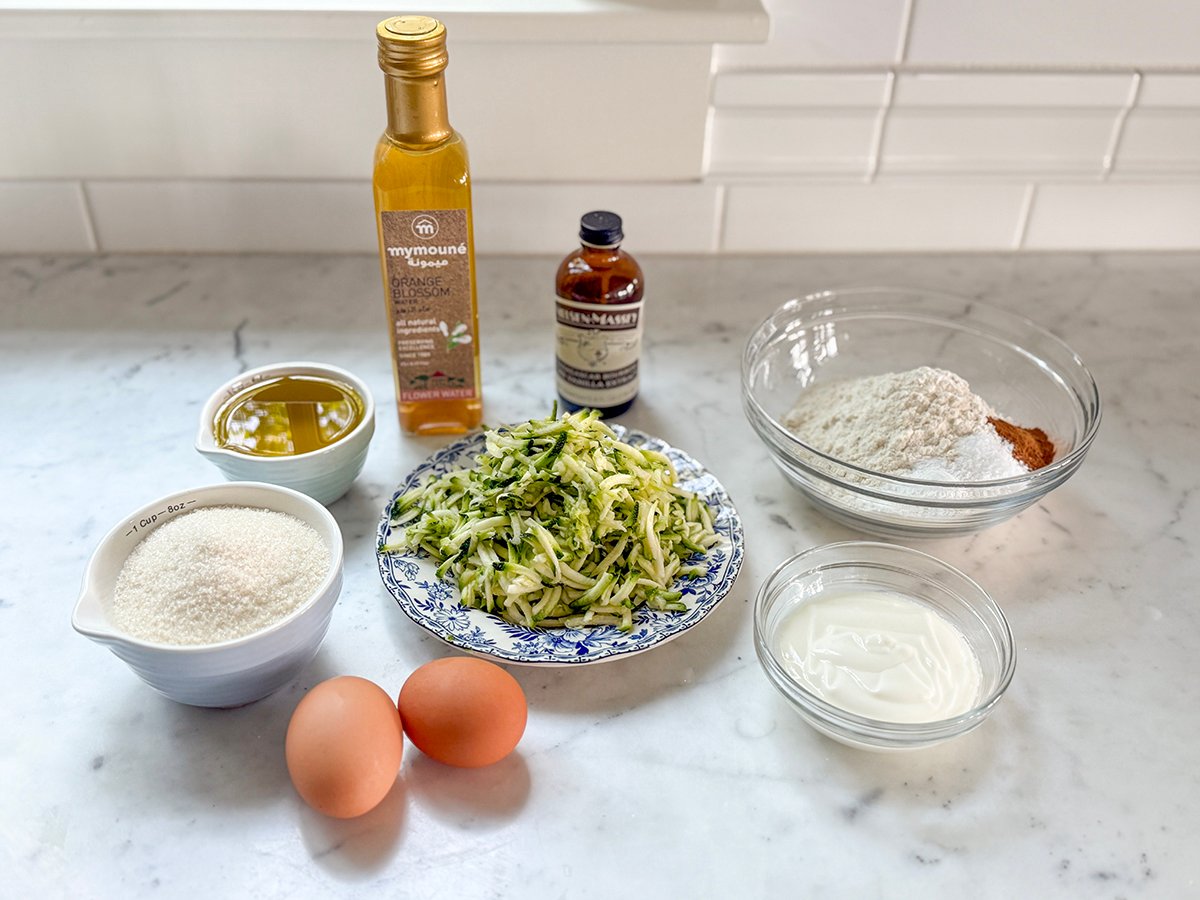 Ingredients for zucchini bread on a marble counter