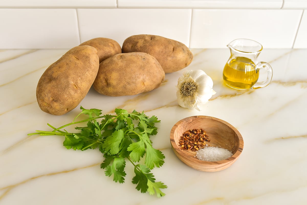 Ingredients for batata harra on a marble countertop
