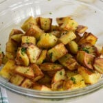 spicy lebanese potatoes flecked with cilantro in a bowl