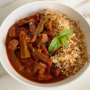 okra stew in a white bowl with Lebanese rice