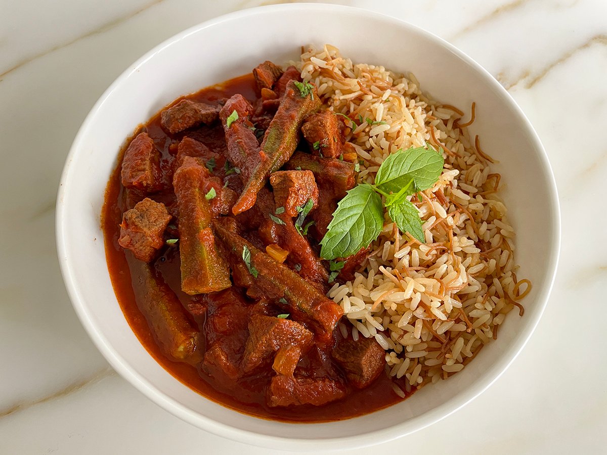 okra stew in a white bowl with Lebanese rice
