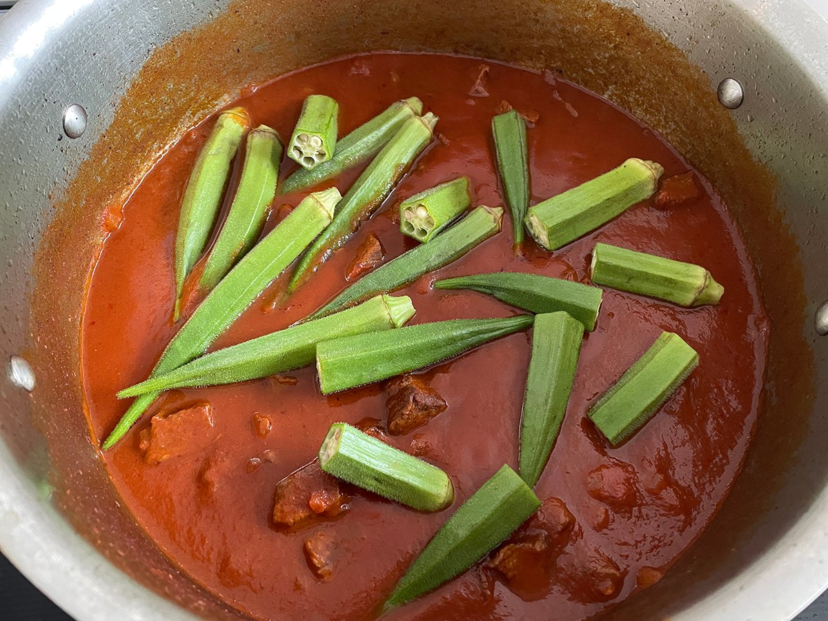 okra in tomato sauce in a pan for okra stew
