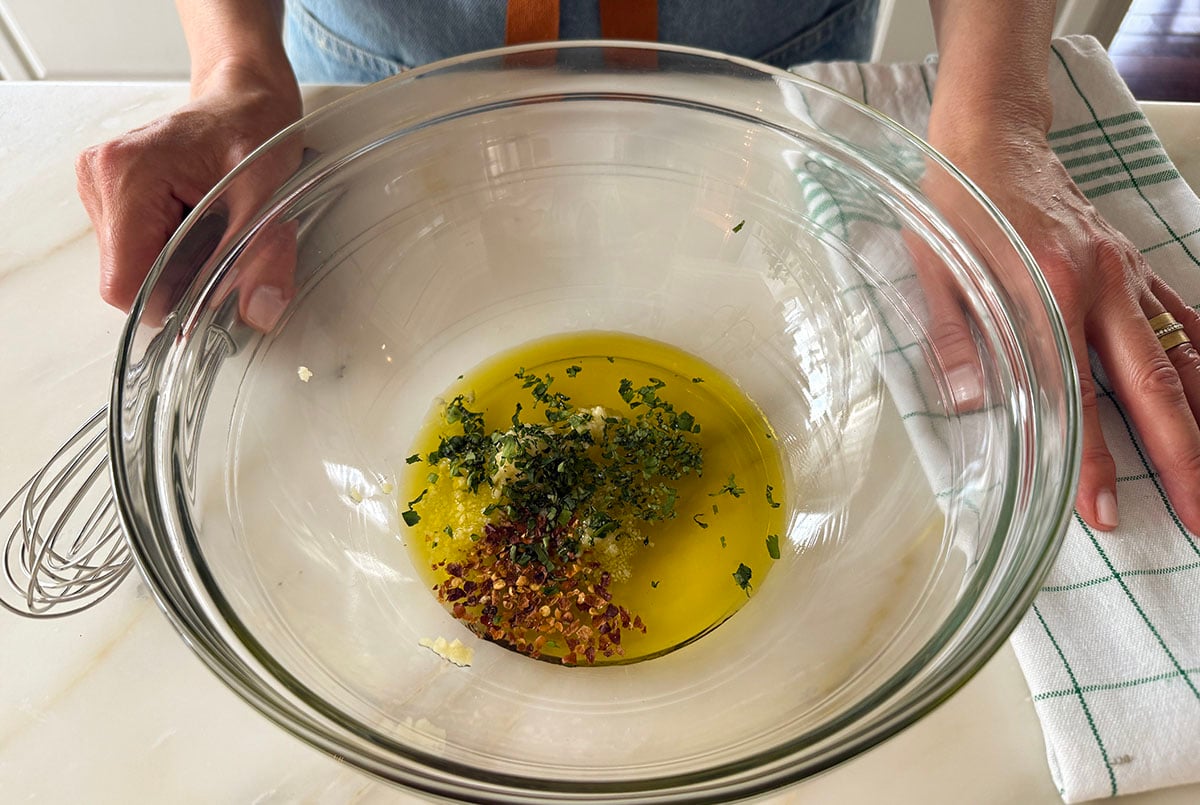 olive oil and herbs in a glass bowl