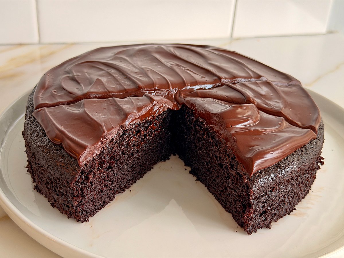Frosted chocolate cake with one piece missing