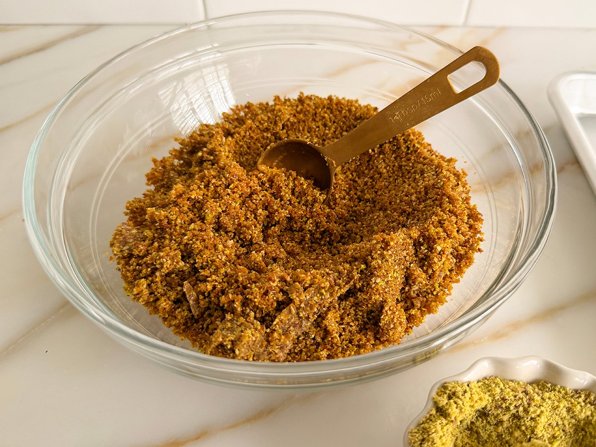 ground ingredients in a bowl with gold tablespoon