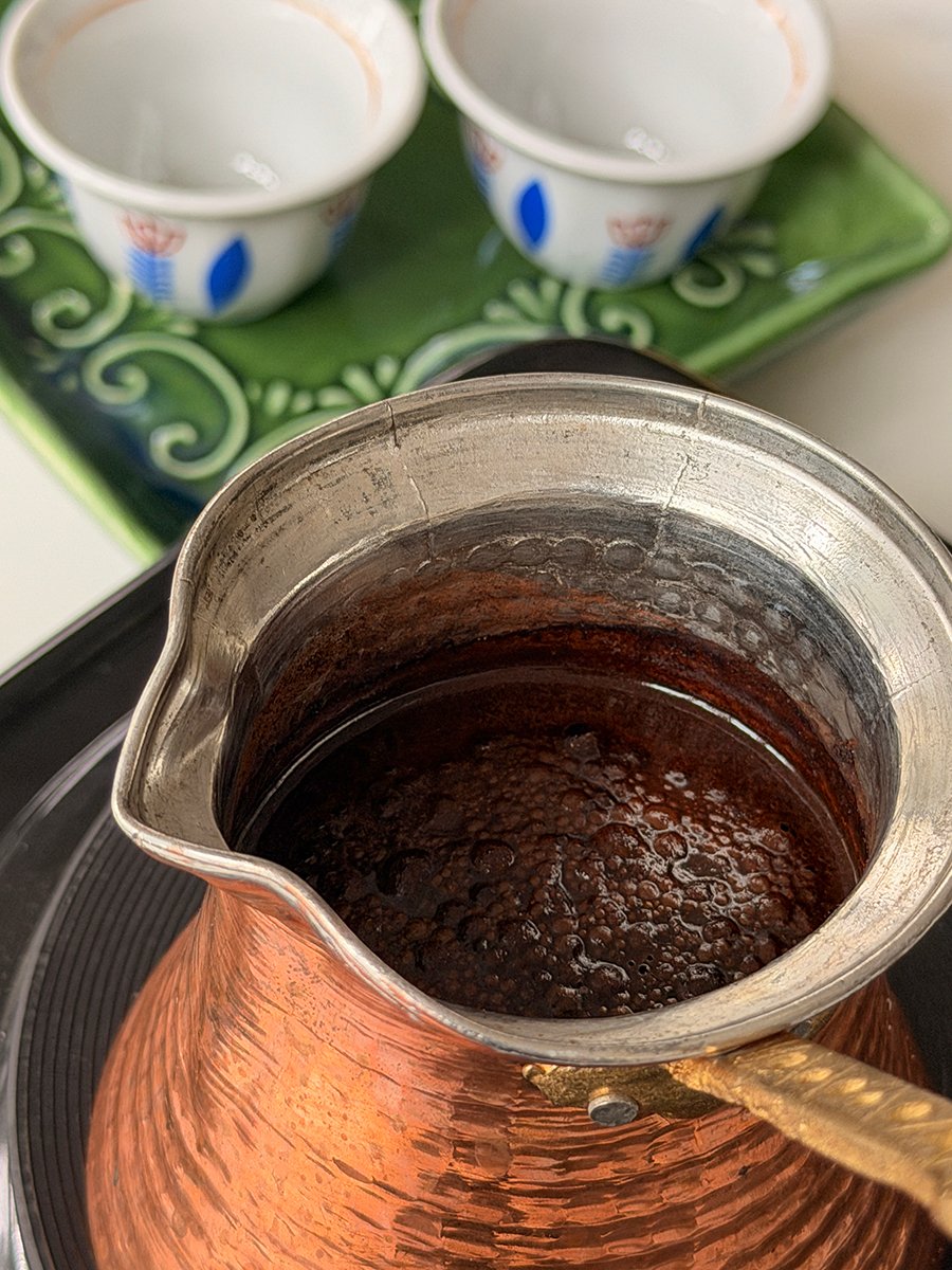 Arabic coffee boiling in an ibriq pot