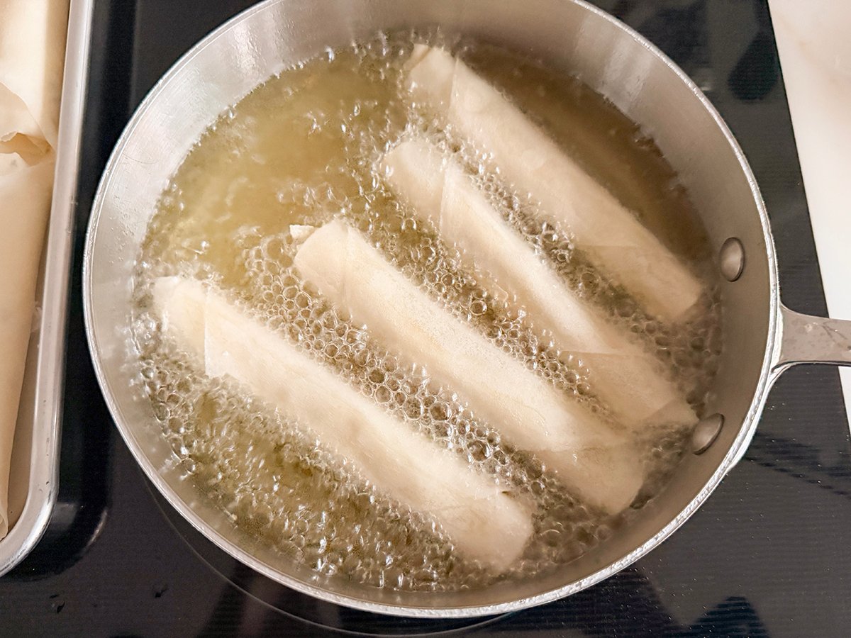 white rolls frying in hot oil