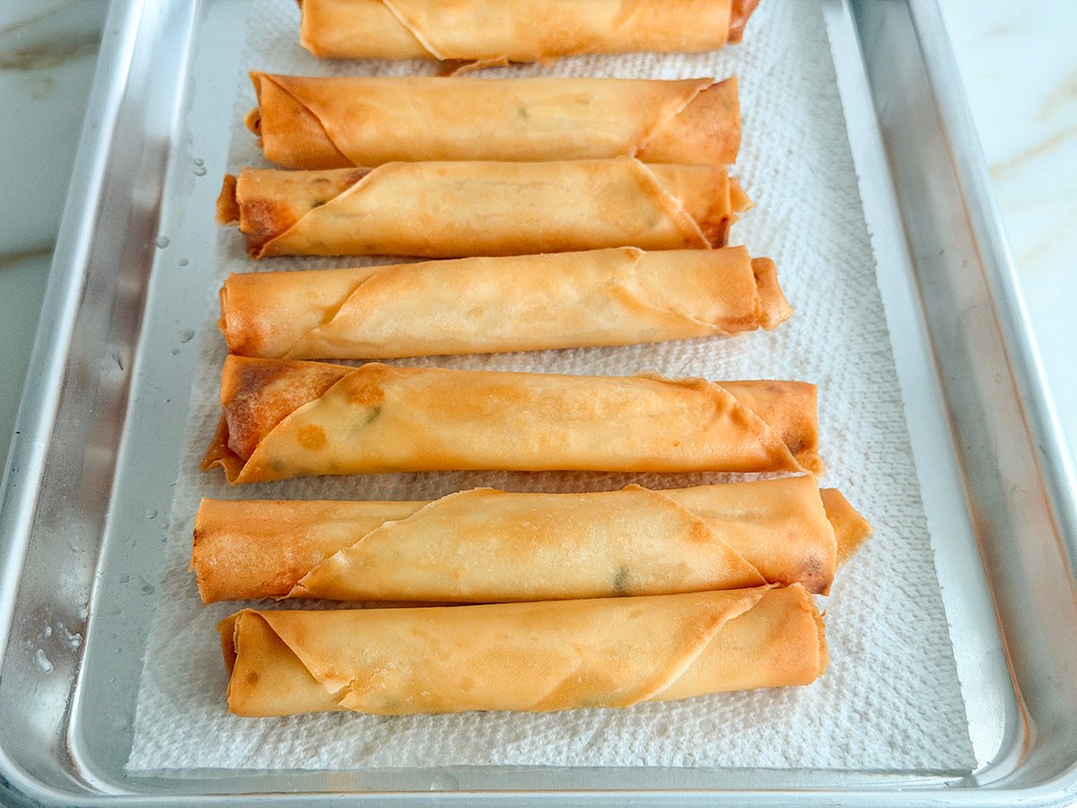 fried cheese rolls on a baking sheet