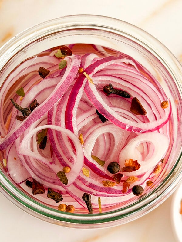 Pickled red onions in a jar with no lid