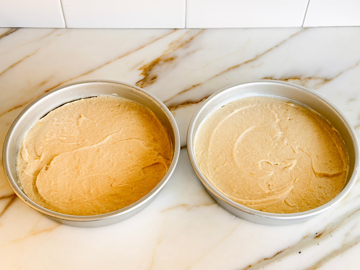 Batter leveled out in two round cake pans