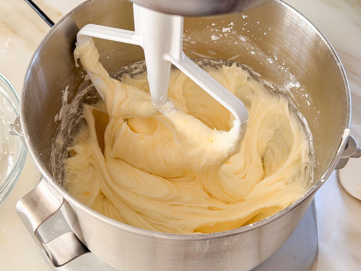 Lemon cream cheese frosting in the bowl of the stand mixer