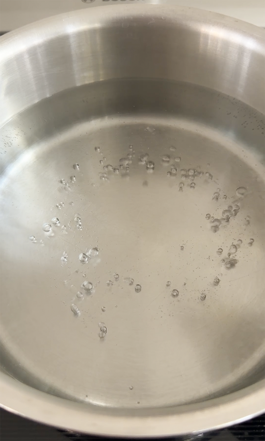 Boiling water in a stainless steel pot.