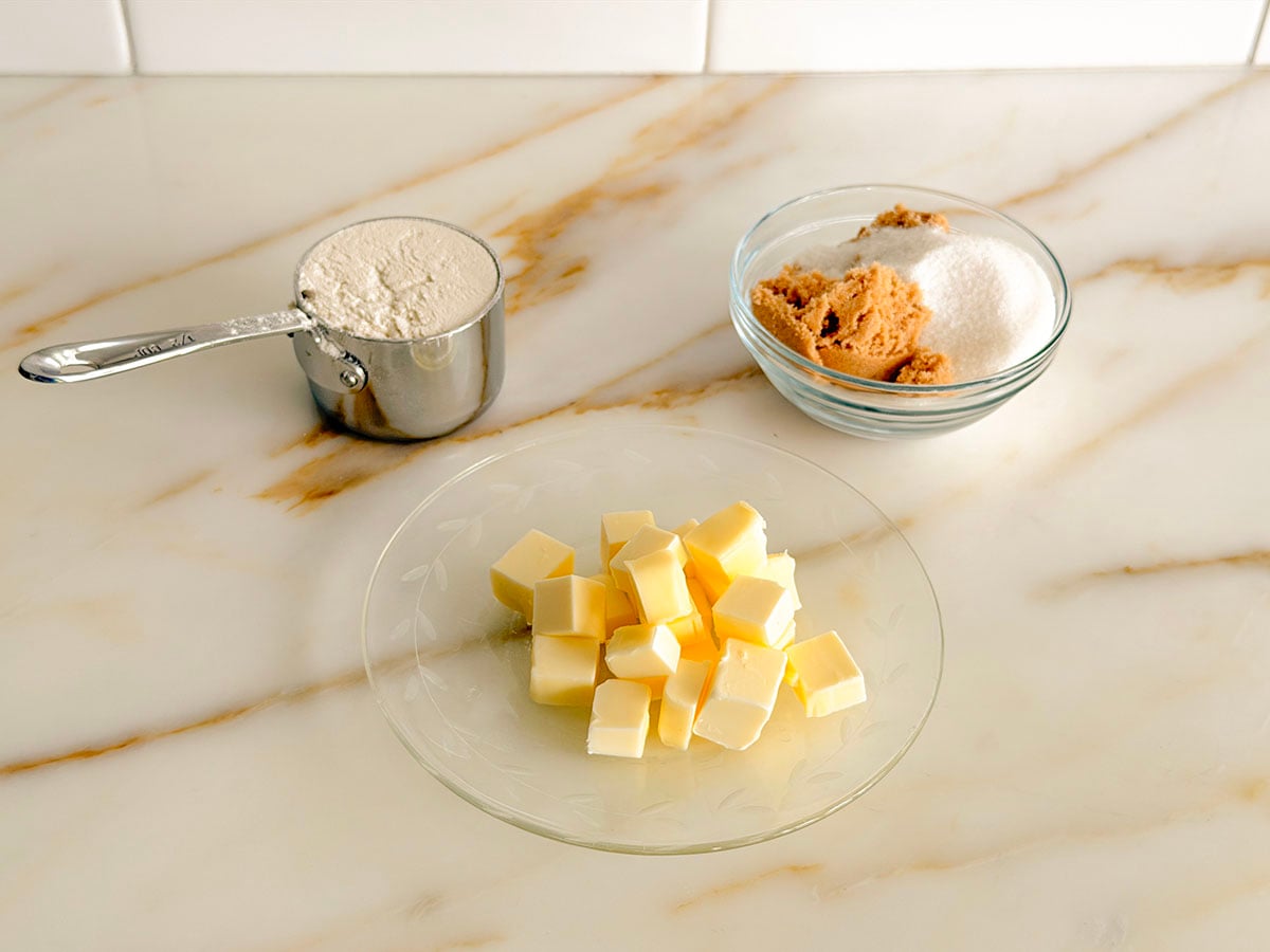 Ingredients for crumb topping for muffins on a marble countertop