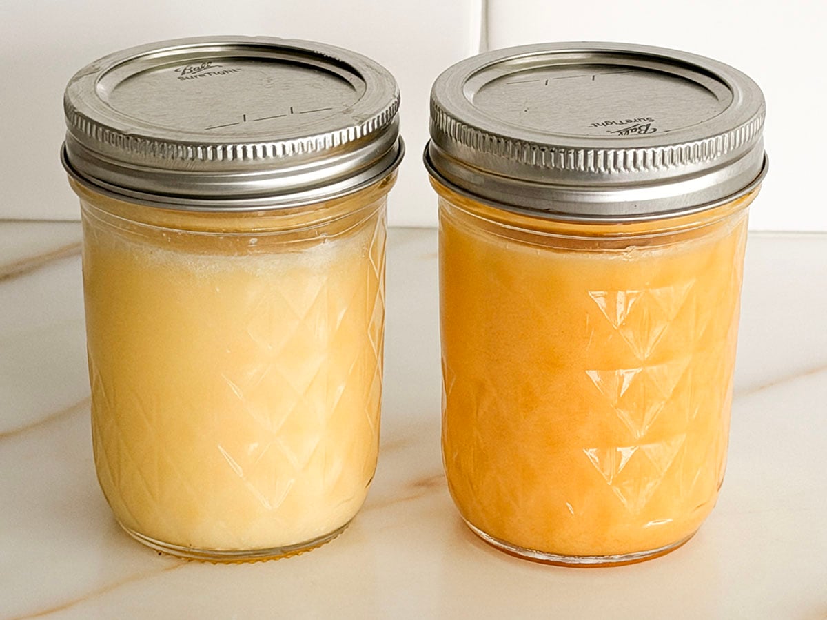 Solid clarified butter and ghee in jars side by side