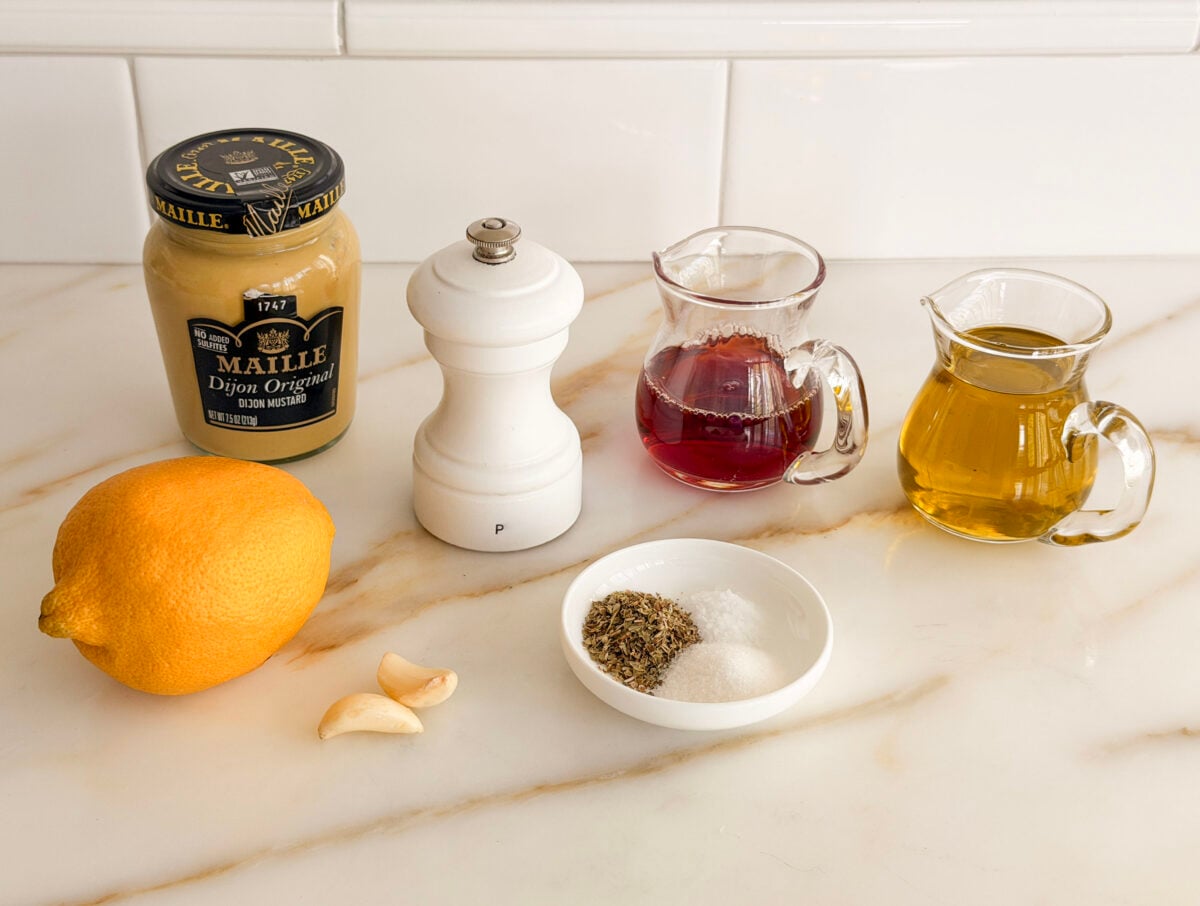 Ingredients for Greek Salad dressing on a marble countertop