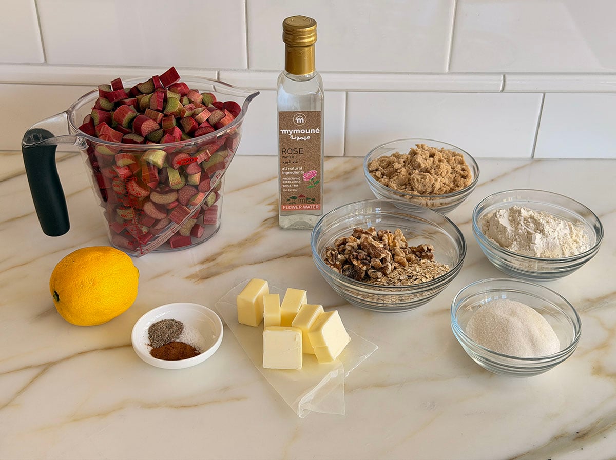 Ingredients for rhubarb crisp on a marble countertop