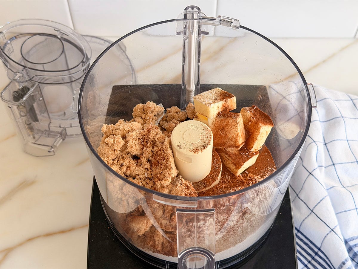 Butter and sugar in a black food processor