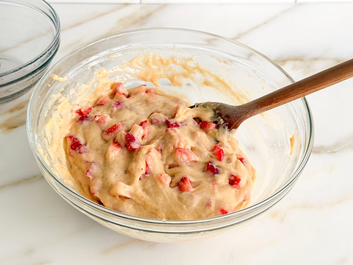 Strawberry muffin batter in a glass bowl