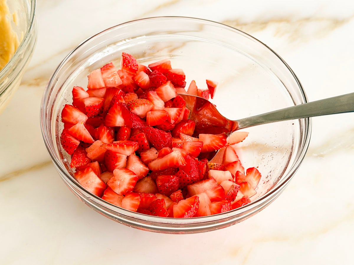 Macerated diced strawberries in a glass bowl