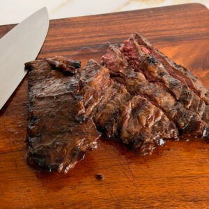 Grilled marinated steak on a cutting board