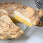 Lemon meringue pie slice lifting from the pie