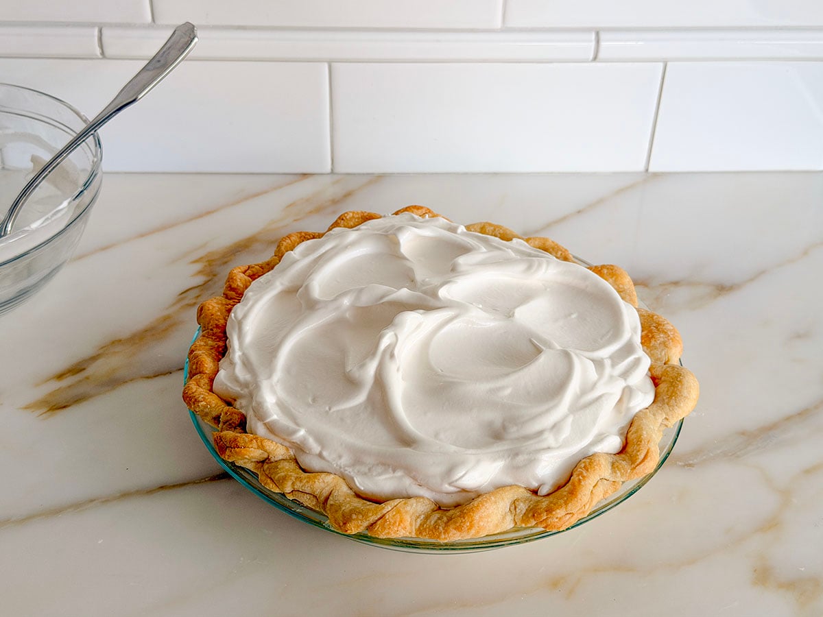 Lemon pie with meringue on top before baking