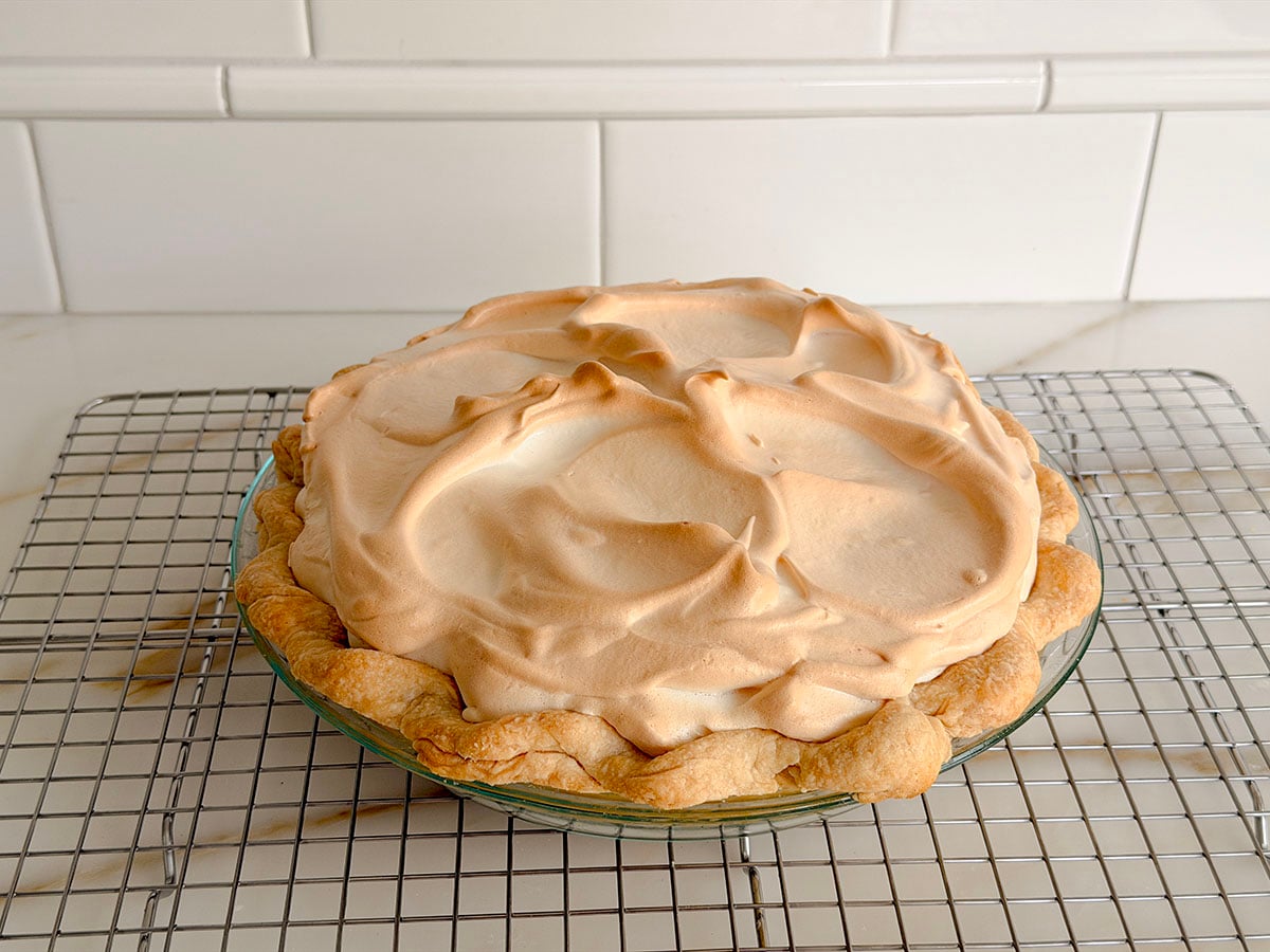 Lemon meringue pie on a cooling rack