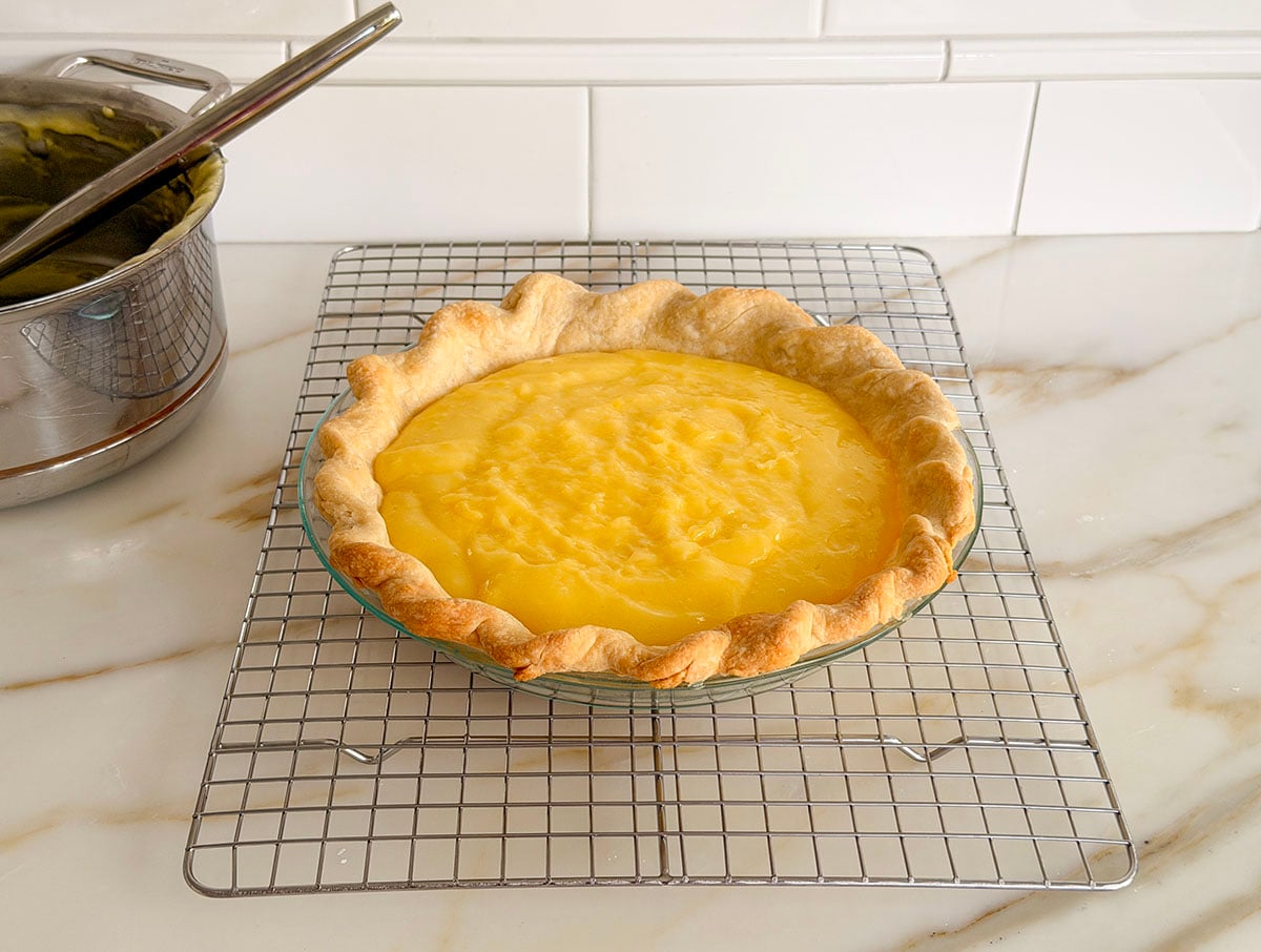 Lemon pie filling in a crust on a cooling rack