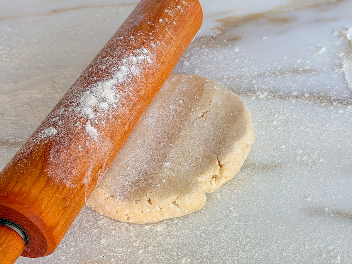 Pie dough with wood rolling pin on top