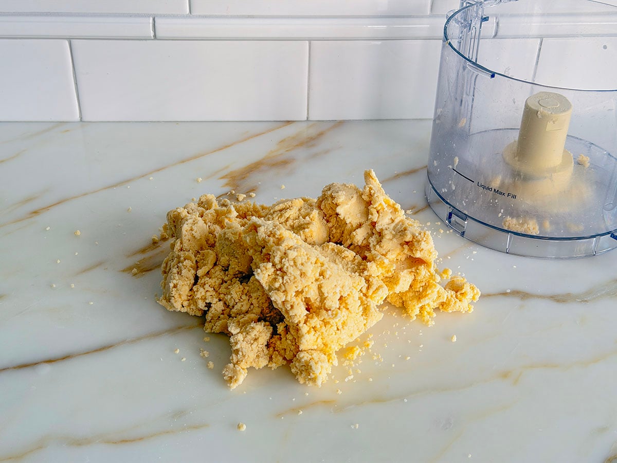 Pie dough crumbles on a marble countertop